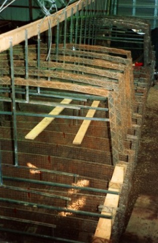 Ribs sections of the the St. Helena III suspended by cables from the Dry Dock roof joists